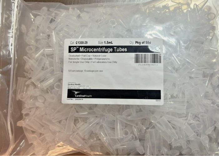 Close-up of Cardinal Health SP Microcentrifuge Tubes, 1.5 mL, natural color, with flat snap caps, arranged in a case of 5000, model C1300-29, for laboratory use.